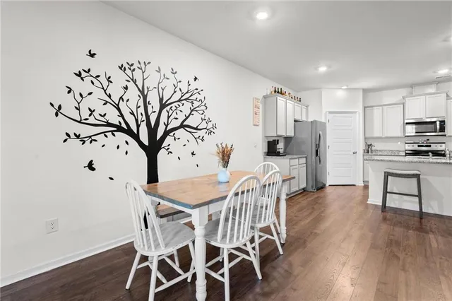 a view of a dining room with furniture and wooden floor