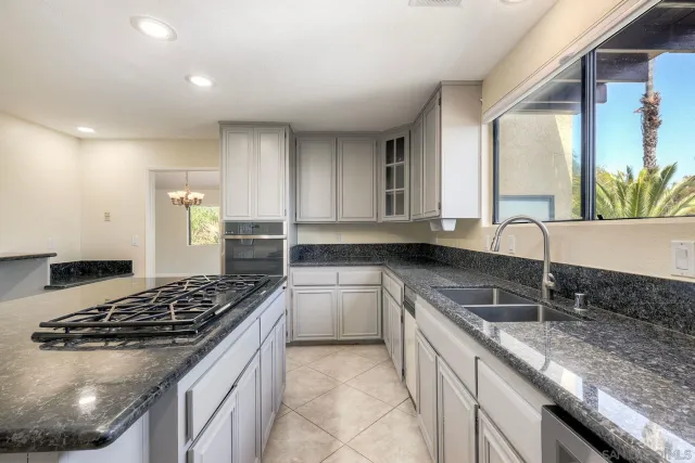 a kitchen with a stove a sink and a refrigerator