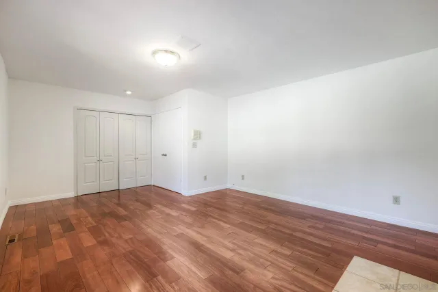 an empty room with a empty space and windows