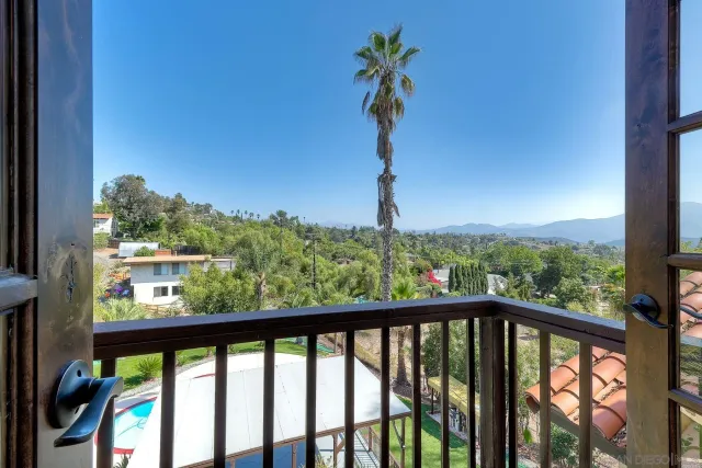 a bathroom with a granite countertop double vanity and a mirror