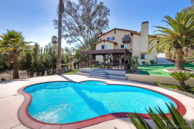 a aerial view of a house with a yard basket ball court and outdoor seating