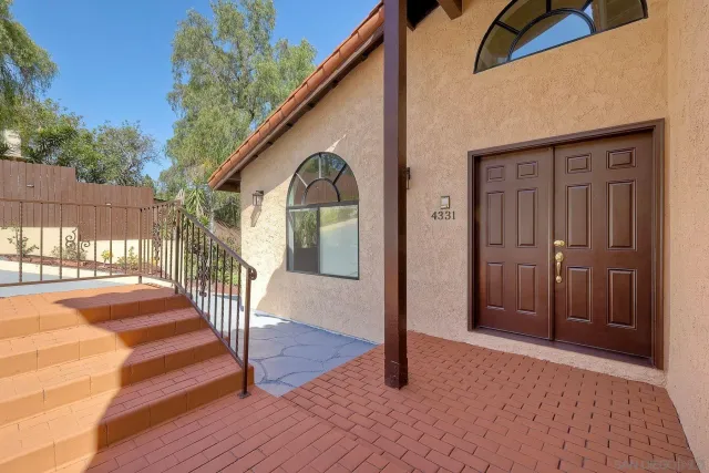 a view of a porch with wooden floor and fence