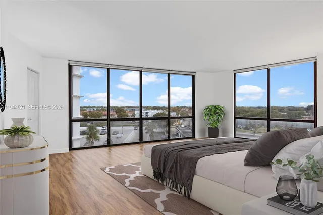 a bedroom with a large bed and a large window