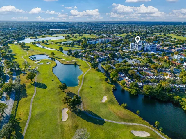 an aerial view of residential houses with outdoor space and swimming pool