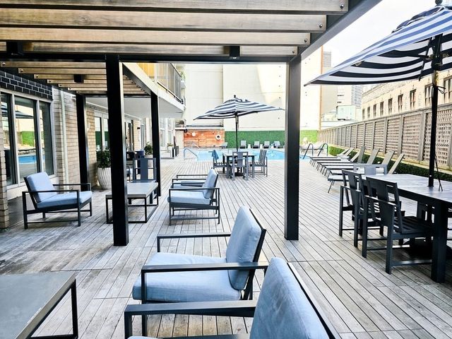 a dining room with furniture a rug and wooden floor