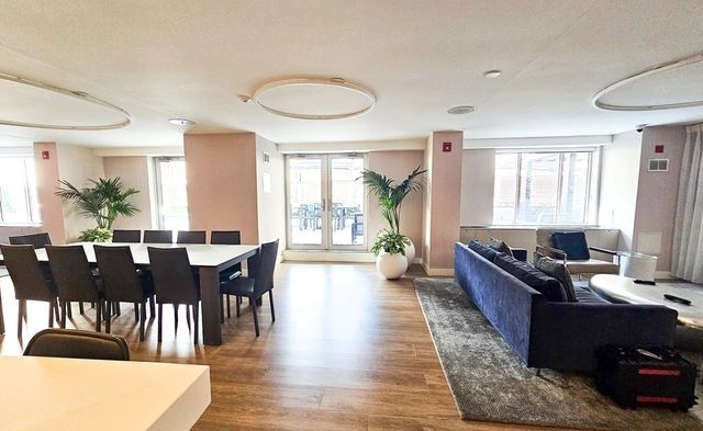 a balcony with wooden floor and outdoor seating