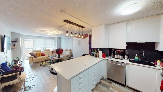 a bathroom with a sink and mirror with bathtub