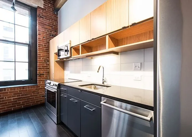 a kitchen with a sink a refrigerator and window