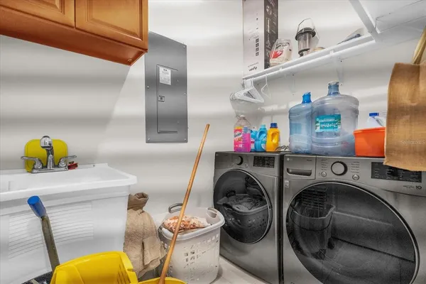 a utility room with dryer washer and other items