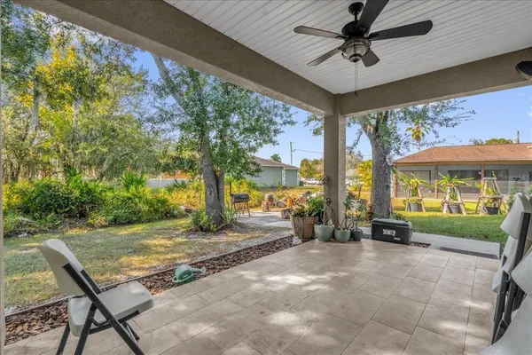 a view of a porch with furniture and a yard