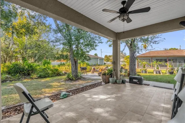 a view of a porch with furniture and a yard