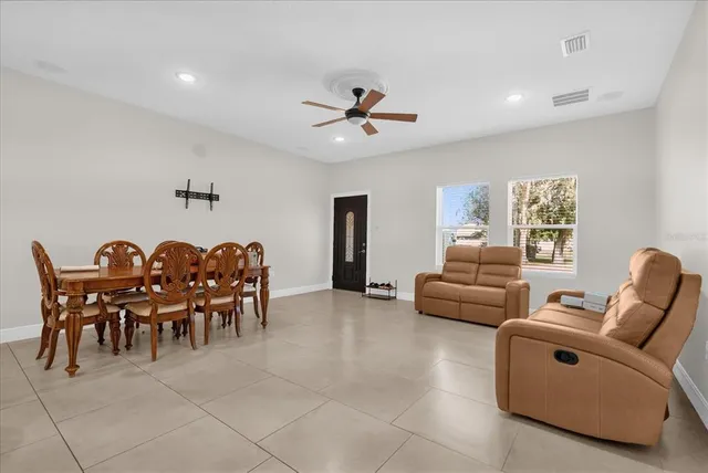 a dining room with furniture and a chandelier