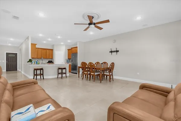 a living room with furniture and a ceiling fan