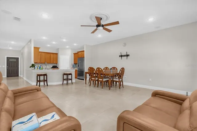 a living room with furniture and a ceiling fan