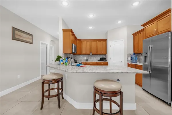 a kitchen with stainless steel appliances a refrigerator and a sink
