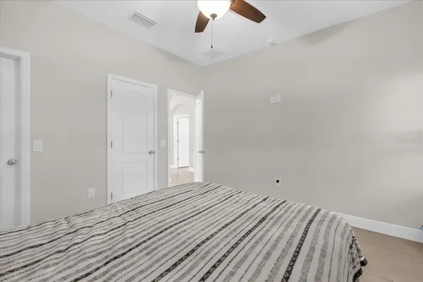 a view of a livingroom with wooden floor and a ceiling fan