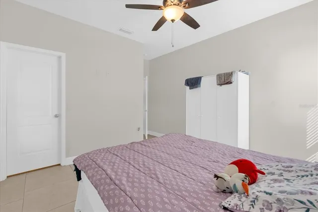 a bedroom with a bed and a chandelier