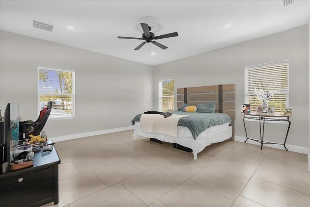 a bedroom with a bed and a couch