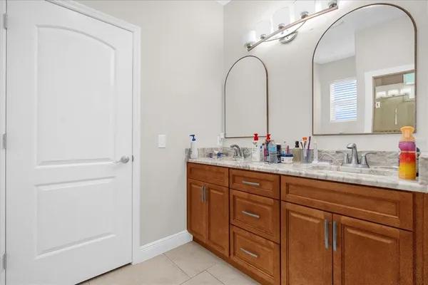 a bathroom with a granite countertop sink a mirror and vanity