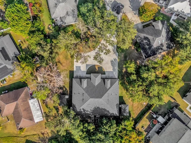 an aerial view of a house with a yard and garden