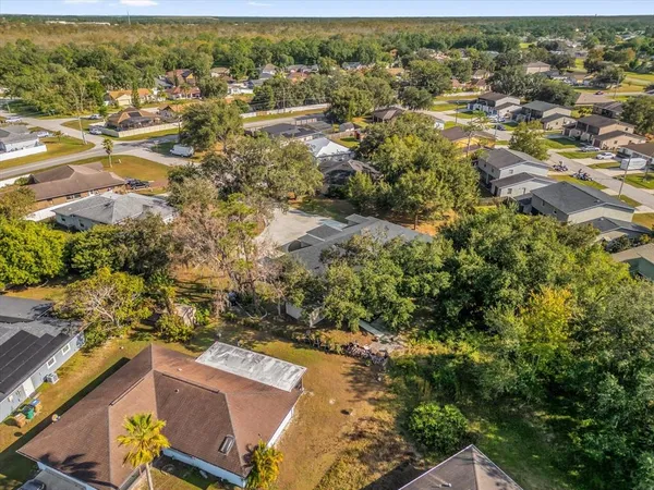 an aerial view of residential houses with outdoor space