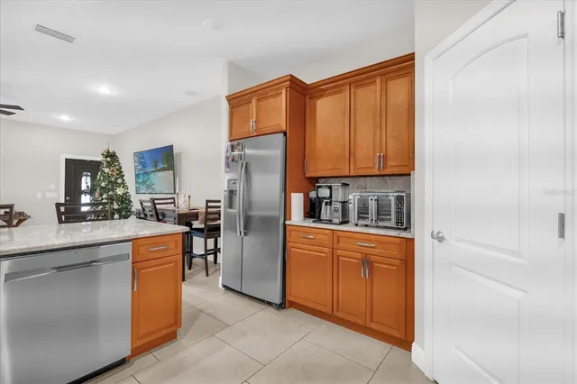 a kitchen with stainless steel appliances granite countertop a refrigerator and a stove top oven
