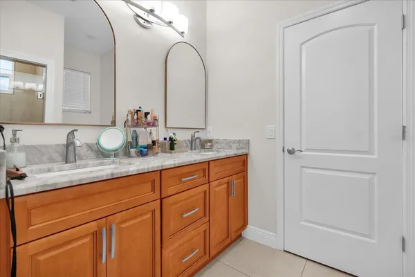 a bathroom with a double vanity sink and a mirror