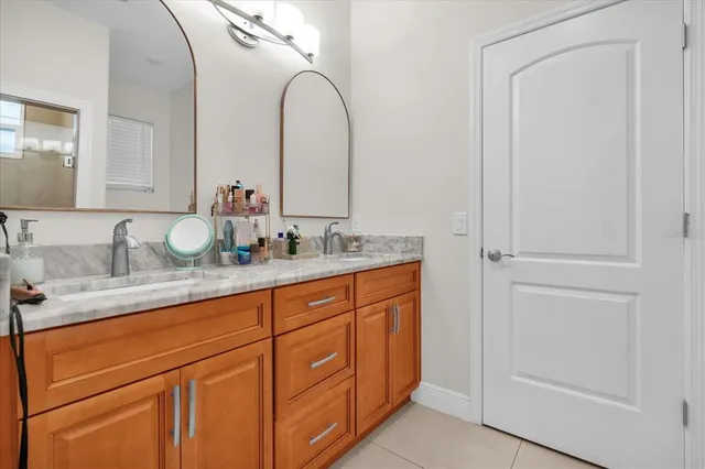 a bathroom with a double vanity sink and a mirror
