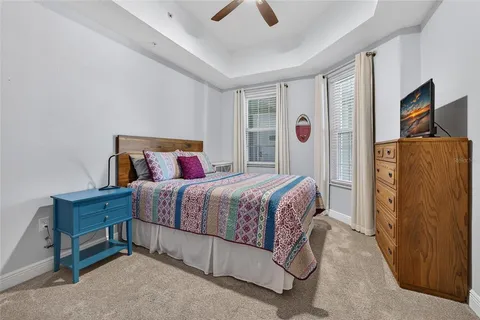 a bathroom with a granite countertop sink a toilet a mirror and shower
