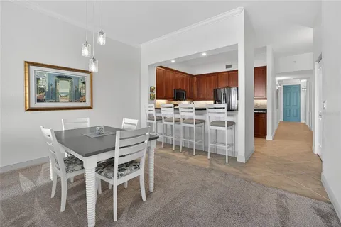 a view of a dining room with furniture and kitchen view