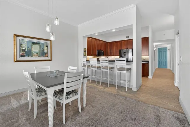 a view of a dining room with furniture and kitchen view