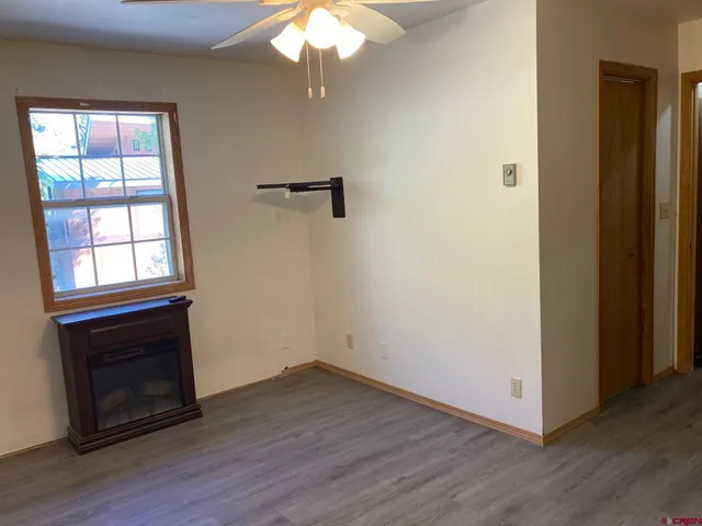 wooden floor in an empty room with a window