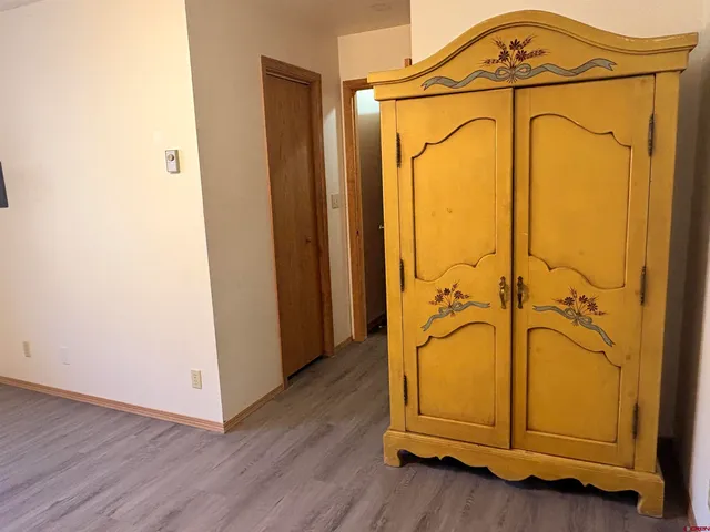 a front view of a house with a garden and mountain view in back