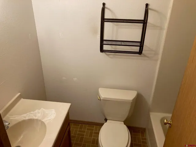 a bathroom with a toilet and a sink