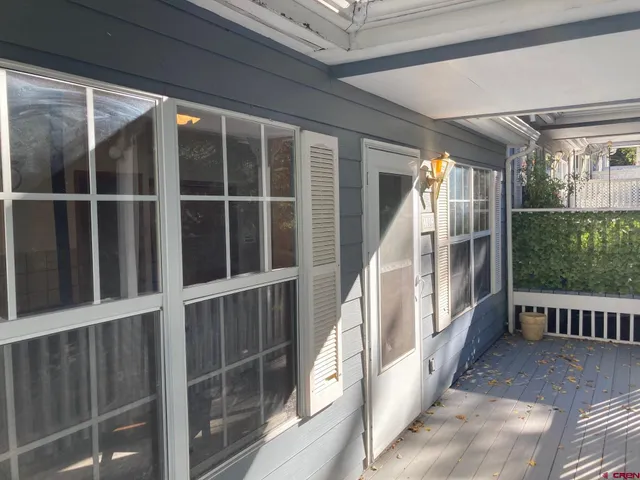 a view of balcony with wooden floor and windows