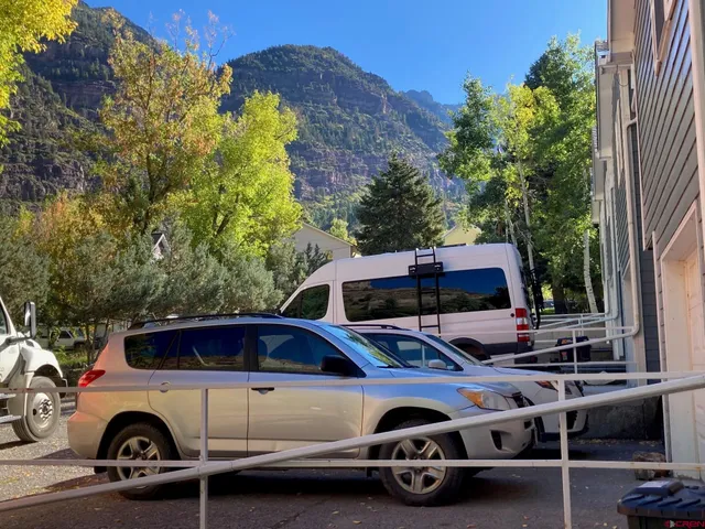 a car parked in front of a car parked in front of a house