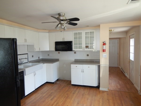 23 Vincent Street Springfield, MA 01129 - Photo 7 of 20 a kitchen with stainless steel appliances a sink stove and refrigerator
