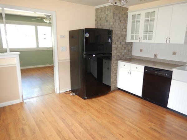 23 Vincent Street Springfield, MA 01129 - Photo 8 of 20 a kitchen with granite countertop a refrigerator and a sink