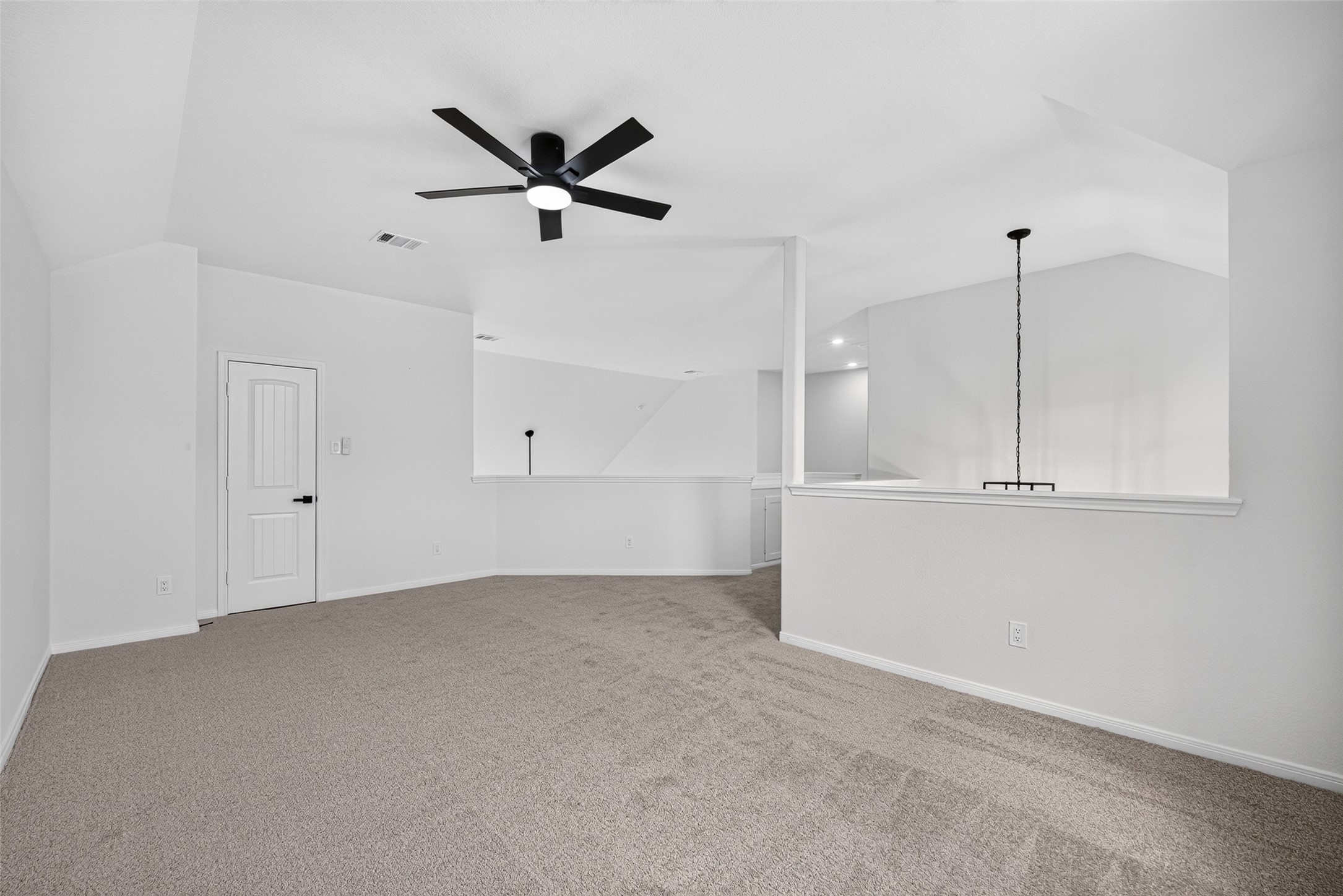 22623 Ebbets Field Drive Spring, TX 77389 - Photo 29 of 43 Look out over the home from this spacious, light-filled loft that seamlessly connects the upper and lower levels. With plush carpeting underfoot, a sleek ceiling fan overhead, and a stylish open railing, it’s the ultimate flexible space—perfect for a cozy media room, quiet reading nook, or a bright home office.