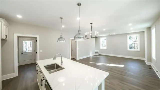a large kitchen with a table chairs and a wooden floor