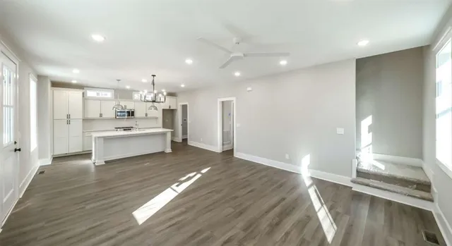 a large white kitchen with lots of counter space and appliances