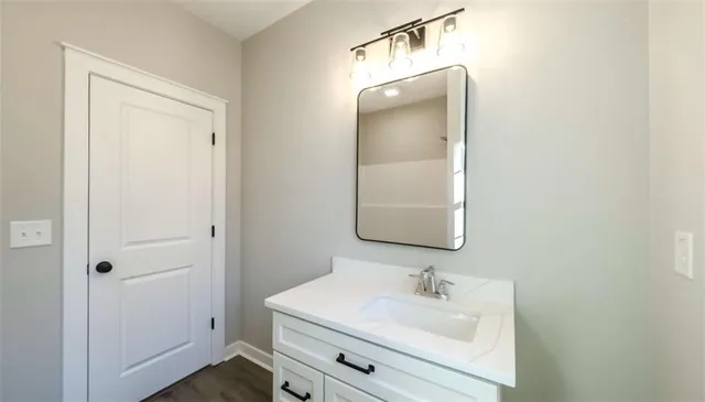 a bathroom with a double vanity sink and a mirror