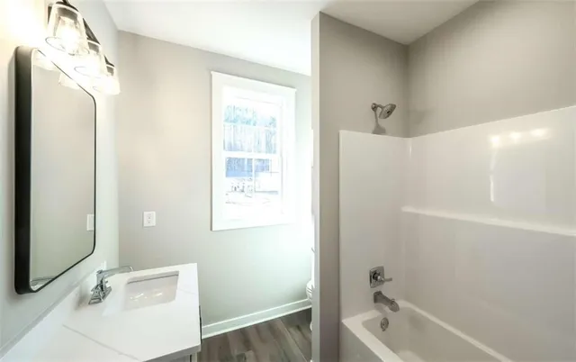 a front view of house with a garden