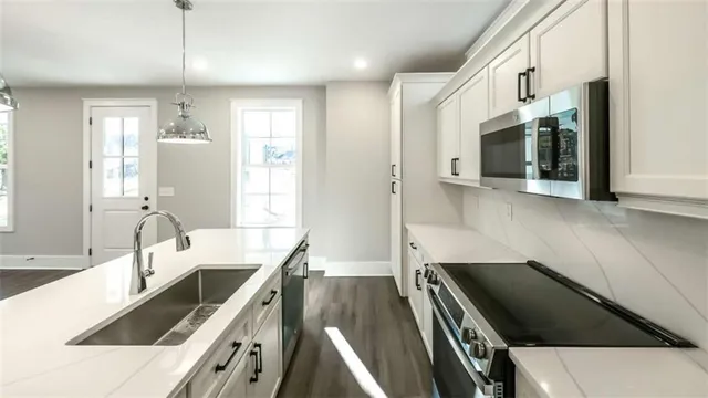a kitchen with a sink and a stove top oven