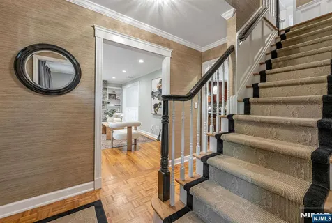 a view of entryway and hall with wooden floor