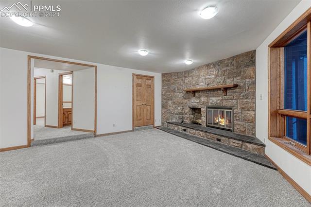 14645 Sterling Road Colorado Springs, CO 80921 - Photo 33 of 49 Newly carpeted and spacious, this inviting space with a focal point fireplace can be a second living room or a guest retreat. You decide!
