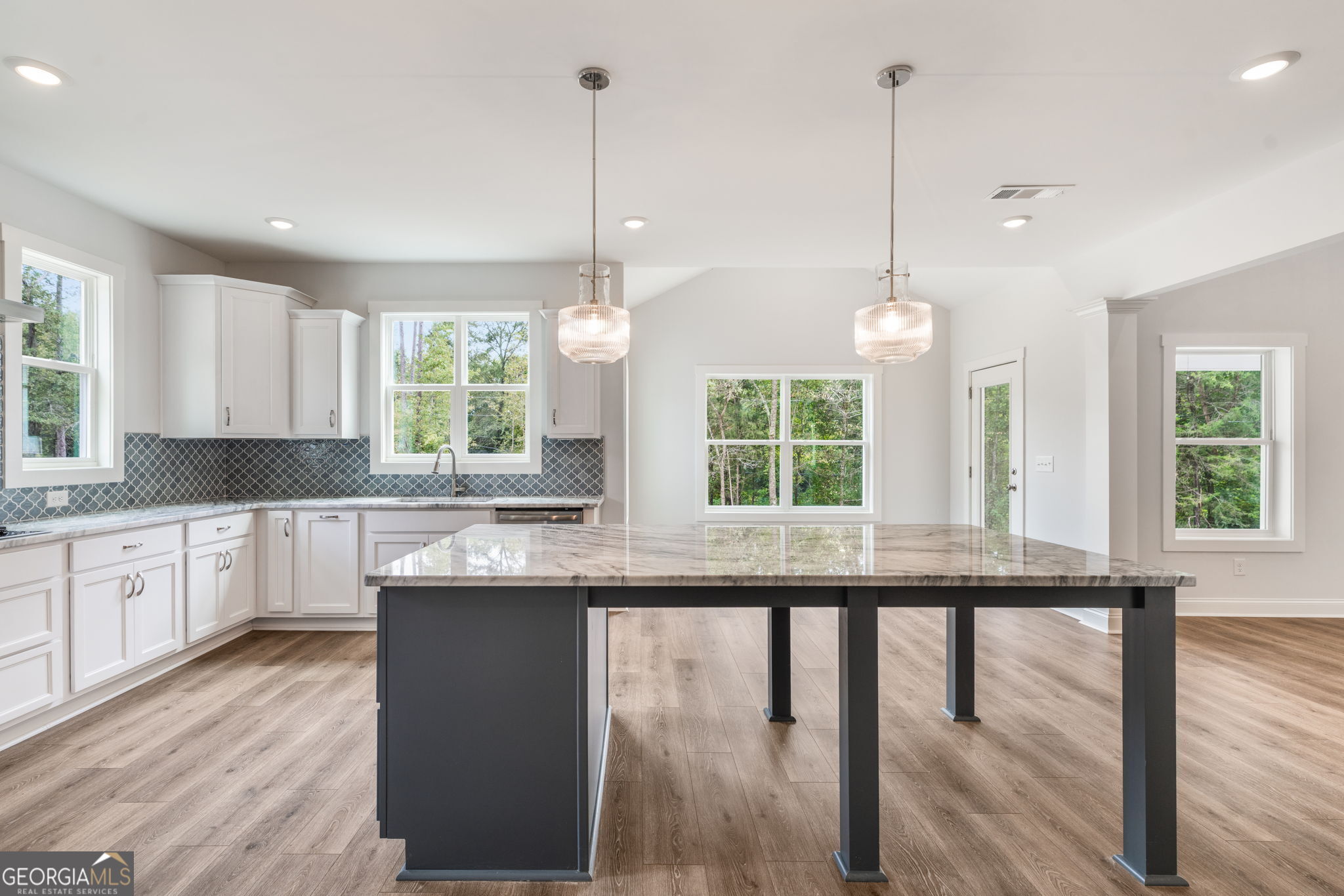 102 Mill Race Road Thomaston, GA 30286 - Photo 12 of 57 a kitchen with stainless steel appliances granite countertop a stove a sink a window and chairs
