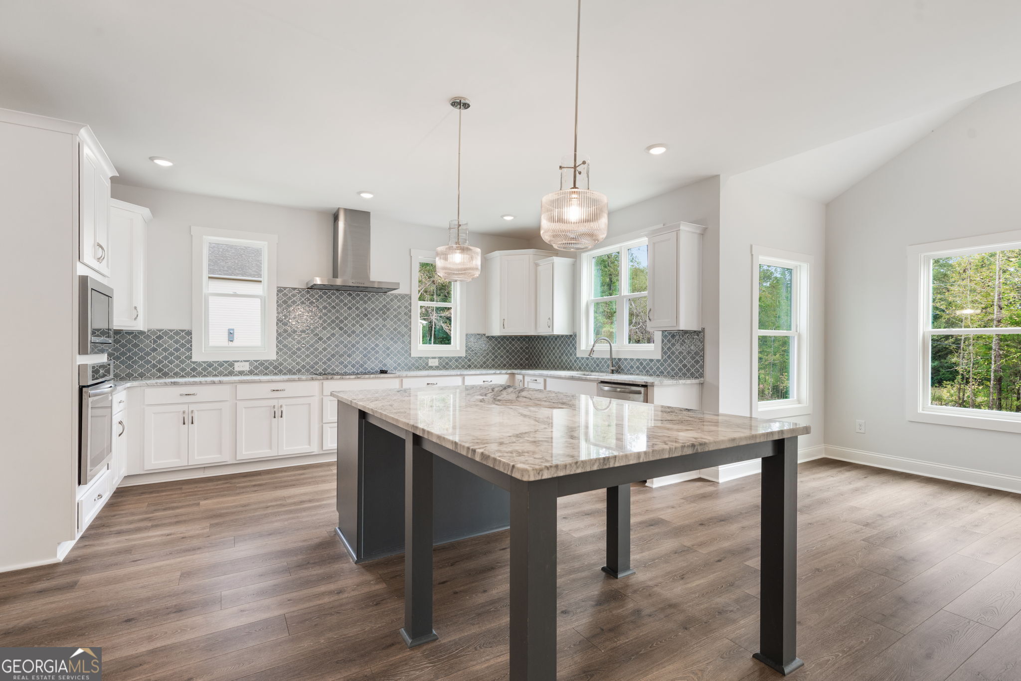 102 Mill Race Road Thomaston, GA 30286 - Photo 13 of 57 a kitchen with stainless steel appliances granite countertop wooden floor window and cabinets