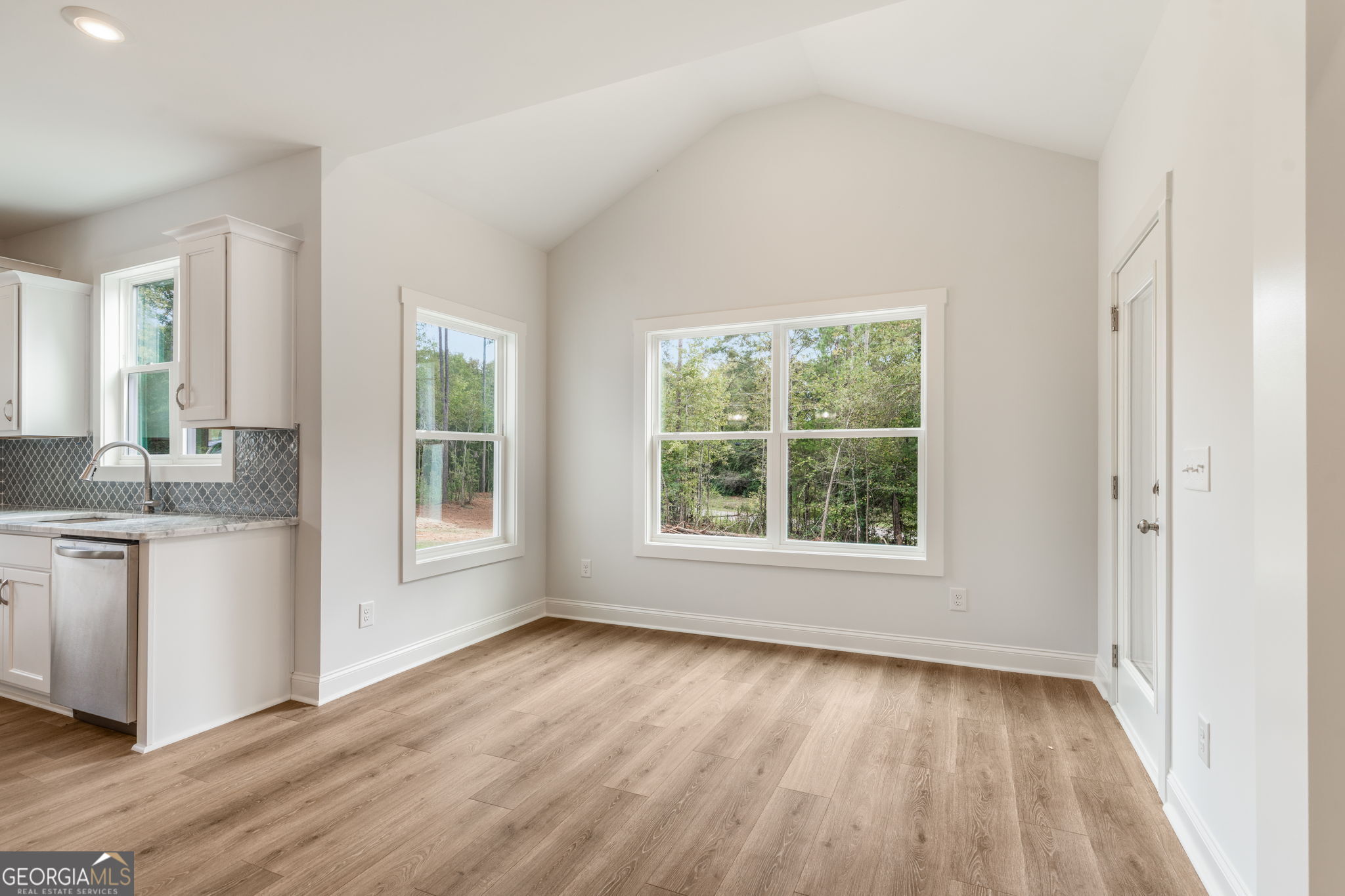 102 Mill Race Road Thomaston, GA 30286 - Photo 14 of 57 a view of an empty room with a window and wooden floor