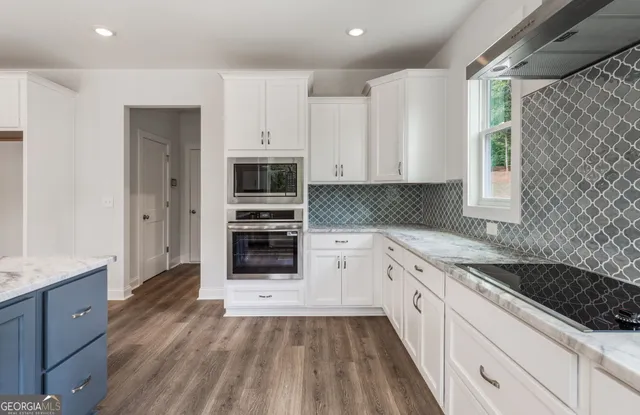 a view of walk in closet with clothes